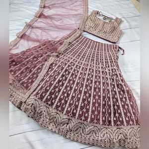 Rose gold Lehenga Choli with heavy stone work, embroidery and real mirror work